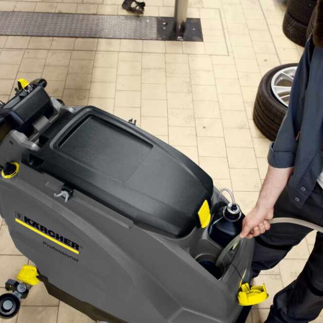 Filling a scrubber dryer with detergent and water