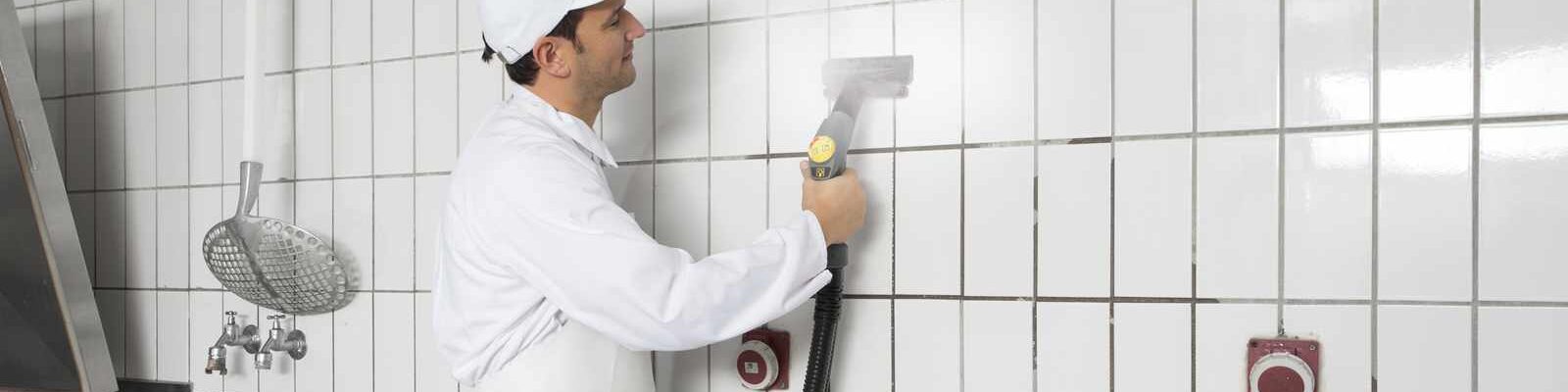 steam cleaning tiled walls in a commercial kitchen